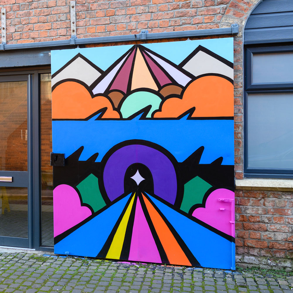 Colourful mural with abstract shapes and bold lines; features mountains, clouds, and a psychedelic landscape in vibrant pink, blue, orange, and green on a brick wall.